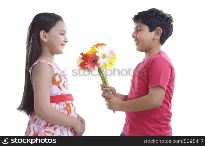 Boy giving flowers to a girl