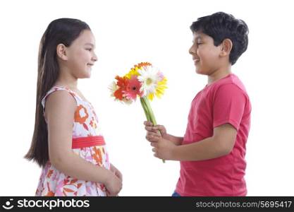 Boy giving flowers to a girl