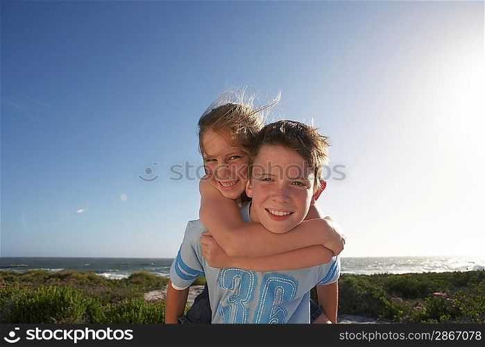 Boy Giving Sister Piggyback Ride