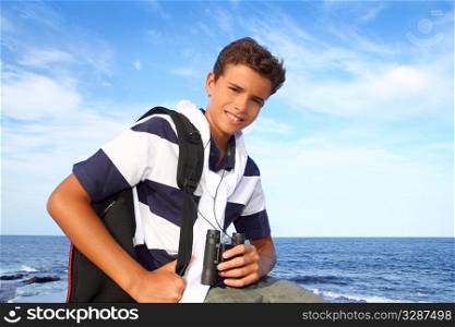 boy handsome teenager summer binoculars explorer in blue beach