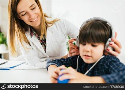 Boy Having a Hearing Exam in the Audiologist’s Office. Hearing Test for Children - Little Boy Doing a Audiometry Test