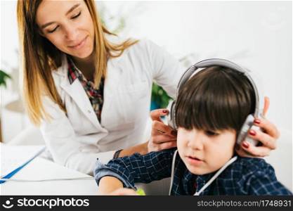 Boy Having a Hearing Exam in the Audiologist’s Office. Hearing Test for Children - Little Boy Doing a Audiometry Test