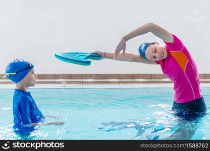 Boy having a swimming lesson with instructor