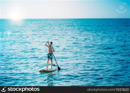 Boy having fun with Stand Up Paddling Board. Stand Up Paddling Board
