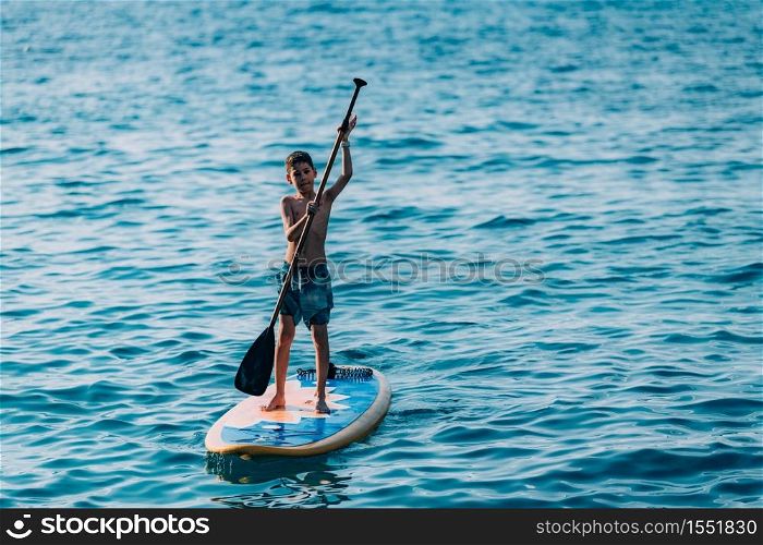 Boy having fun with Stand Up Paddling Board. Stand Up Paddling Board