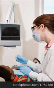 Boy having teeth examined
