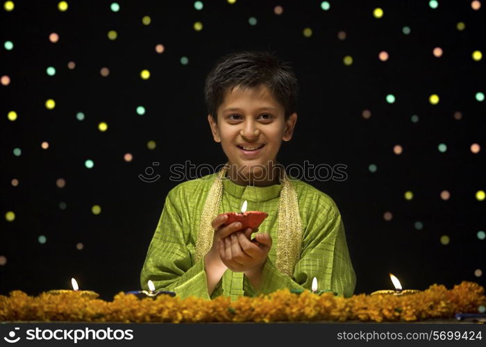 Boy holding Diya