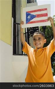 Boy holding drawing of the Puerto Rican flag
