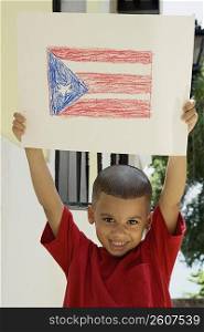 Boy holding drawing of the Puerto Rican flag