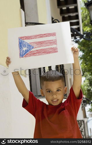 Boy holding drawing of the Puerto Rican flag