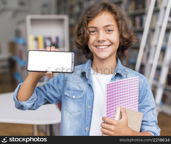 boy holding empty screen phone library