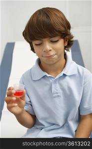 Boy holding liquid medicine