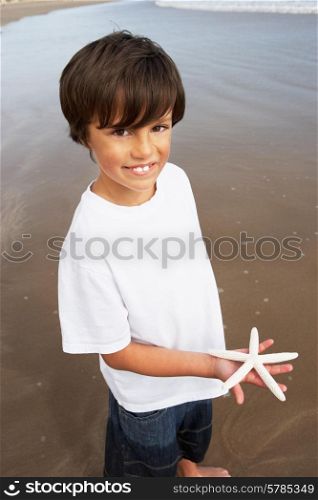 Boy Holding Starfish Found On Beach