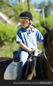 Boy horseback riding