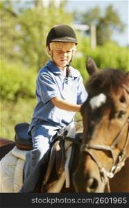 Boy horseback riding
