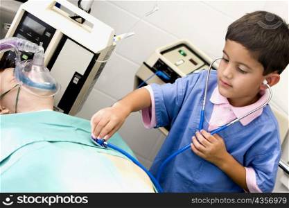 Boy imitating a doctor and examining a patient with a stethoscope