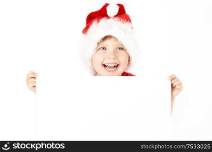 Boy in a cap of santa holds the blank sheet