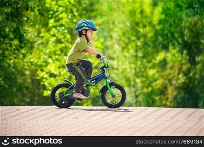 boy in a helmet riding bike. boy riding bike in a helmet