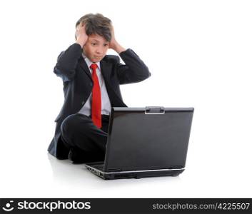 boy in business suit sitting in front of computer. Isolated on white background
