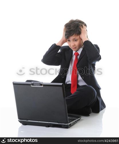 boy in business suit sitting in front of computer. Isolated on white background