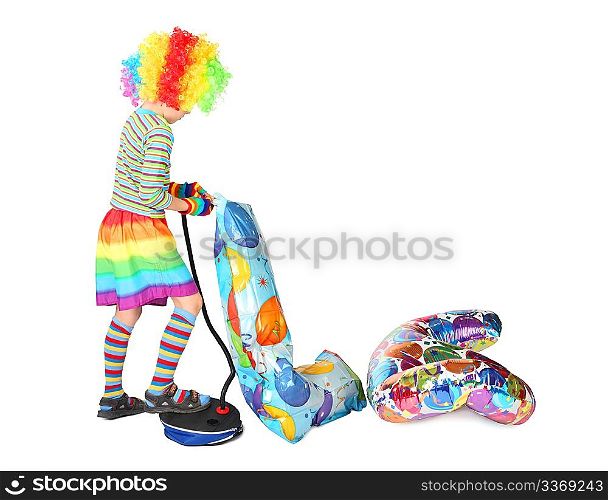 boy in clown dress pupming birthday balloons isolated on white background