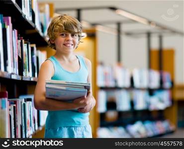 Boy in library choosing books. Boy in library