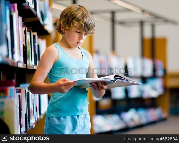 Boy in library choosing books. Boy in library