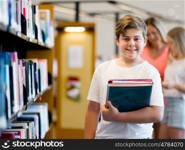 Boy in library choosing books. Boy in library
