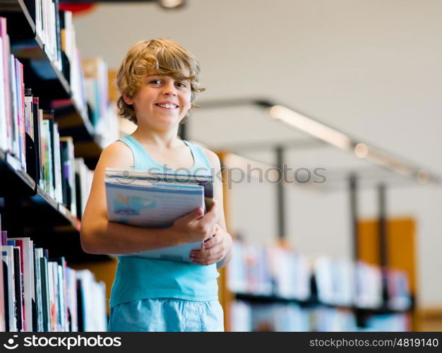 Boy in library choosing books. Boy in library