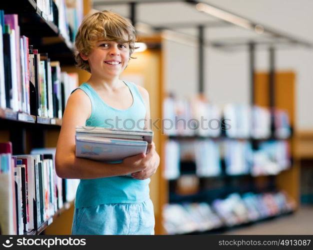 Boy in library choosing books. Boy in library