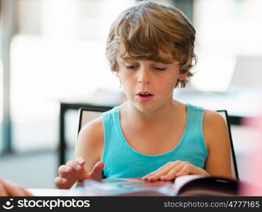 Boy in library with books. Boy in library