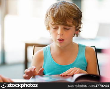 Boy in library with books. Boy in library