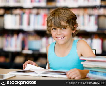 Boy in library with books. Boy in library