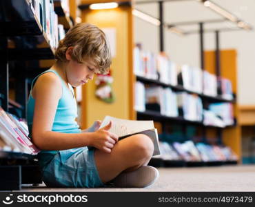 Boy in library with books. Boy in library