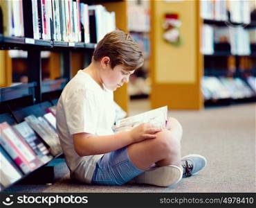 Boy in library with books. Boy in library