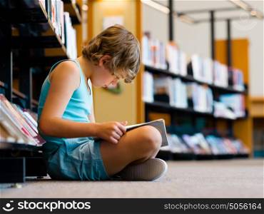 Boy in library with books. Boy in library