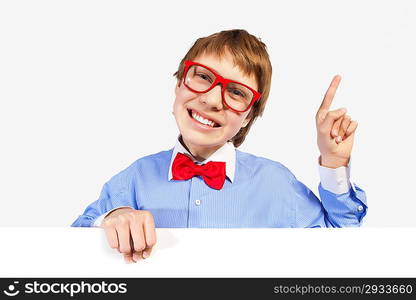 Boy in red glasses holding white square