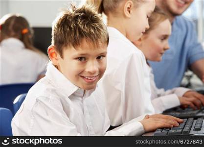 Boy in school class smiling to camera