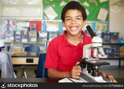 Boy in science class with microscope