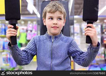 boy in shop on sports exerciser