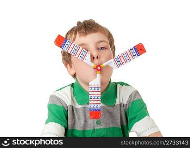 boy in striped T-shirt with toy propeller in mouth isolated on white background