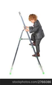 boy in suit rises on step-ladder