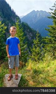 Boy in summer mountain. View from Transfagarasan road (Romania)