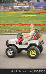 boy in toy car in park