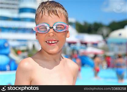 boy in watersport goggles near pool in aquapark of an entertaining complex