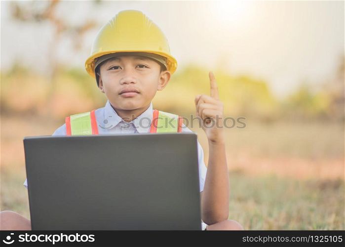 Boy kid engineer hard hat using computer outdoor