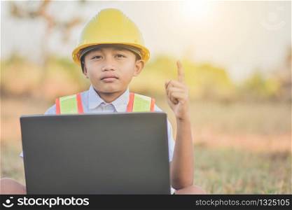 Boy kid engineer hard hat using computer outdoor