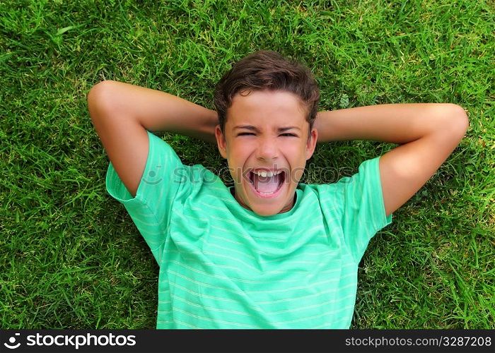 boy laughing happy teenager laying green grass