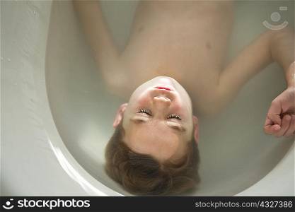 Boy laying in bath