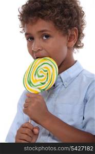Boy licking a lollipop